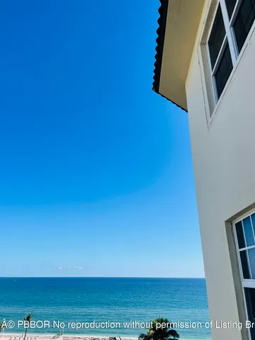 a living room with furniture a rug and a large window