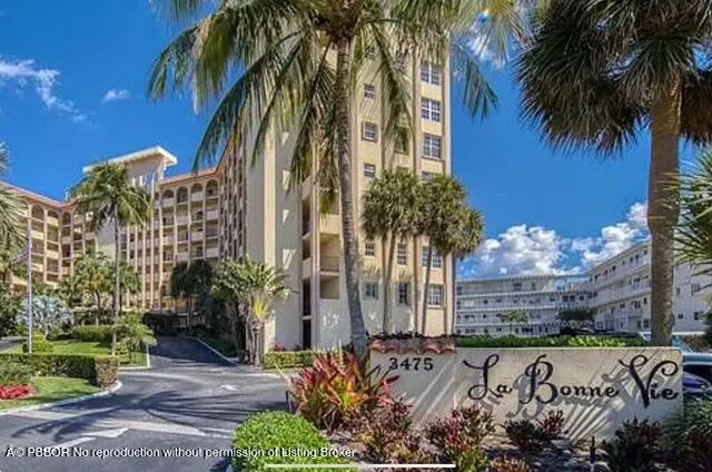 a living room with furniture and a painting on the wall