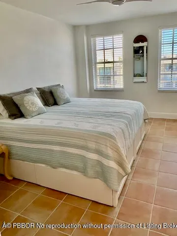 a room with pool table and windows