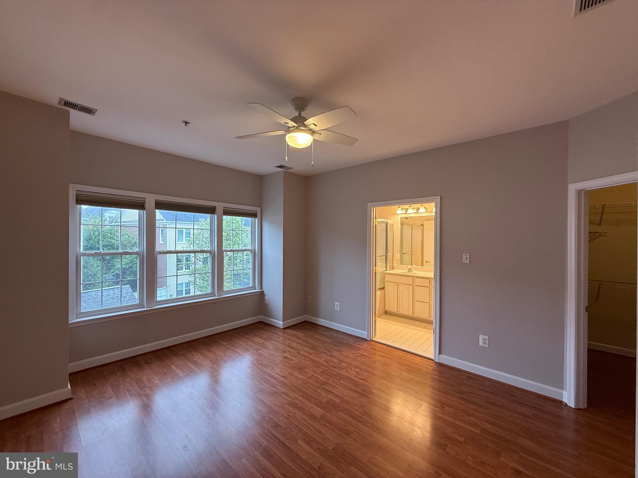1127 Gaither Road Rockville, MD 20850 - Photo 15 of 26 a view of an empty room with wooden floor and a window