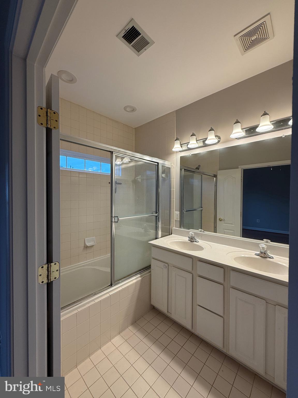 1127 Gaither Road Rockville, MD 20850 - Photo 16 of 26 a bathroom with a double vanity sink mirror and bathtub