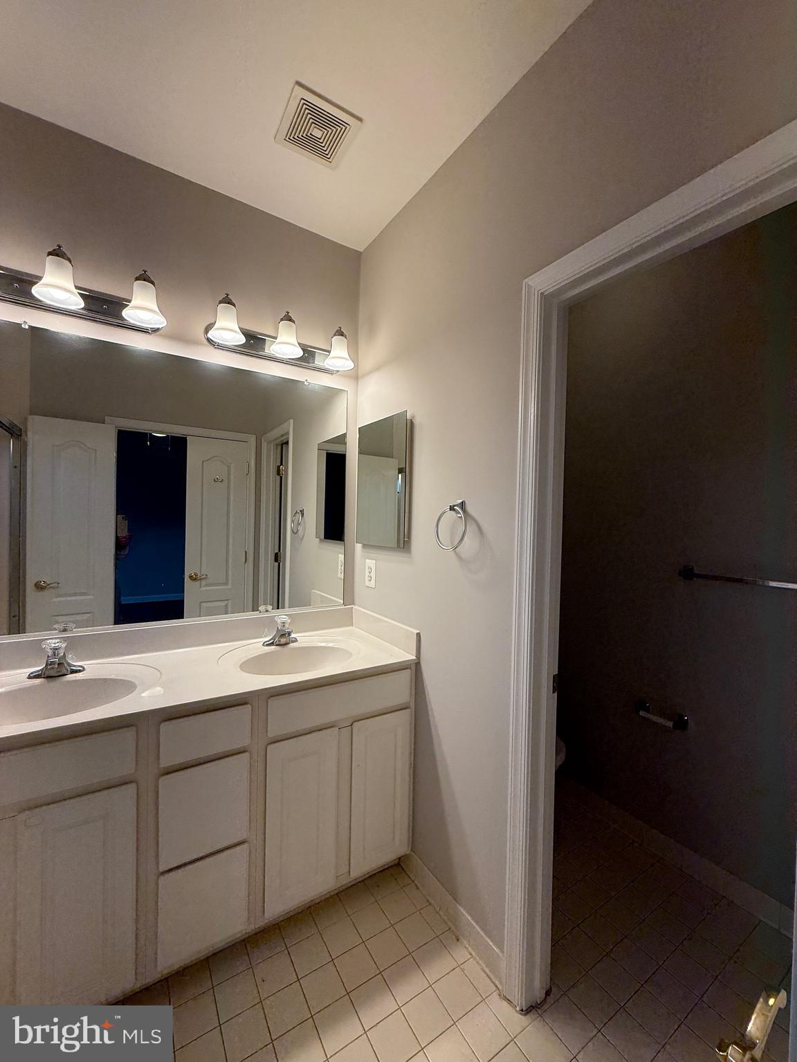 1127 Gaither Road Rockville, MD 20850 - Photo 17 of 26 a bathroom with a double vanity sink and mirror