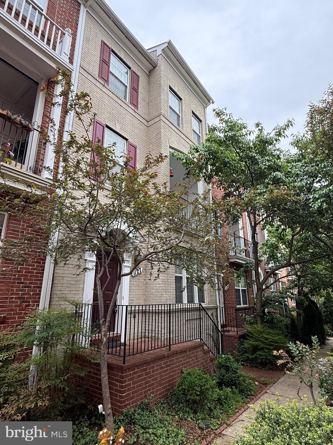 1127 Gaither Road Rockville, MD 20850 - Photo 2 of 26 a front view of a house with a garden