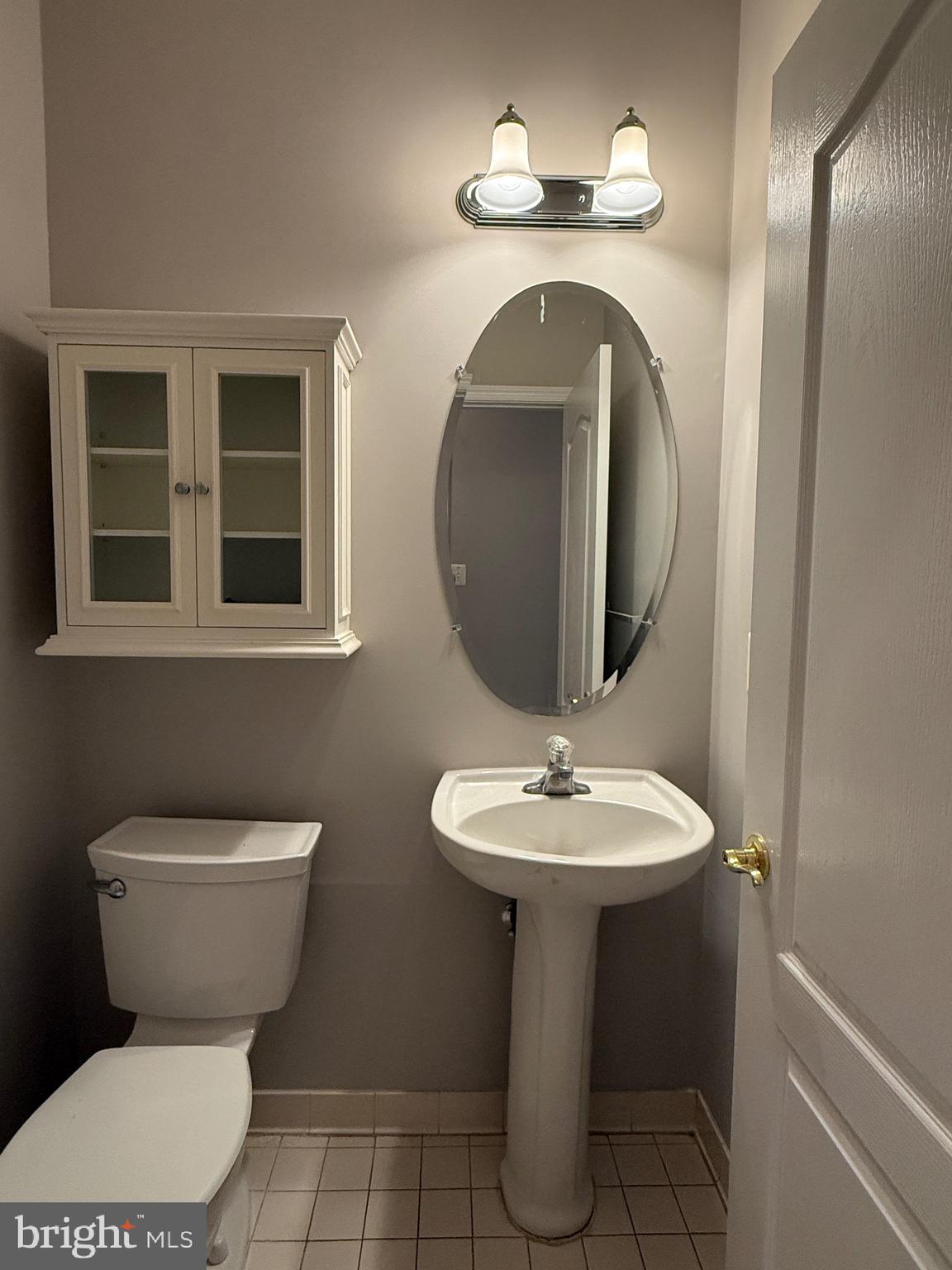 1127 Gaither Road Rockville, MD 20850 - Photo 5 of 26 a bathroom with a toilet sink and mirror
