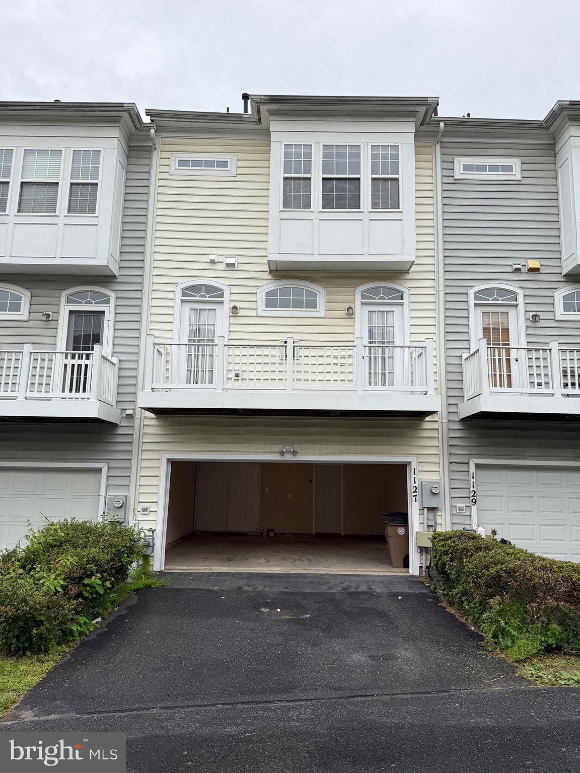 1127 Gaither Road Rockville, MD 20850 - Photo 7 of 26 a front view of a house with a yard