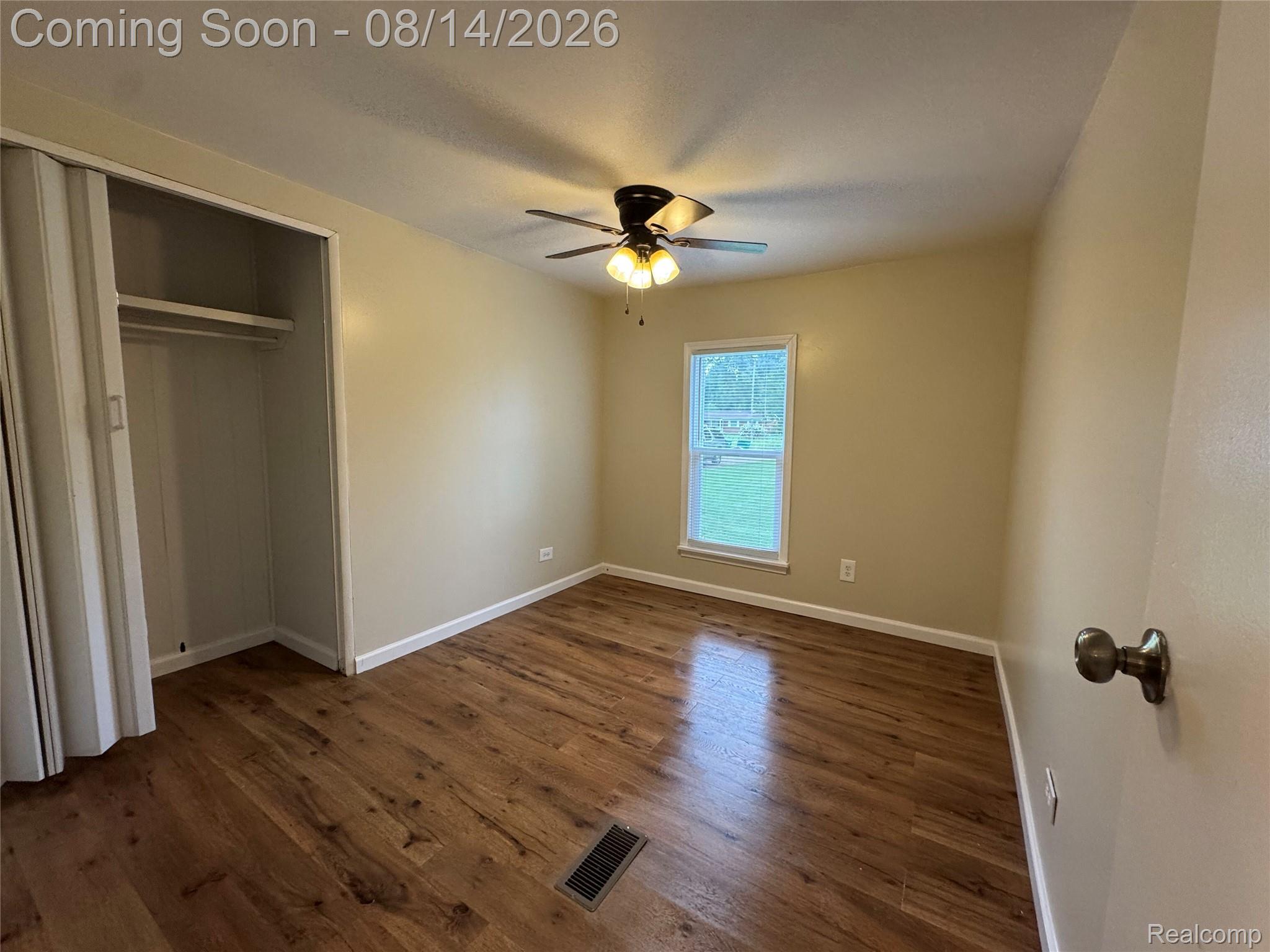 28747 West Road New Boston, MI 48164 - Photo 12 of 19 Wood-finish flooring, ceiling fan with integrated lighting, single window, and bi-fold closet