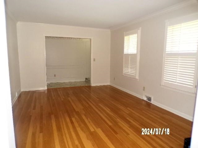 3249 Clarke Road Memphis, TN 38115 - Photo 4 of 24 a view of empty room with window and wooden floor