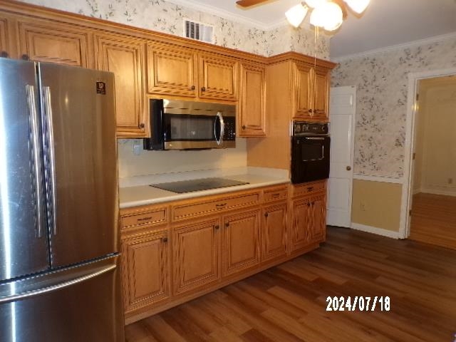 3249 Clarke Road Memphis, TN 38115 - Photo 6 of 24 a kitchen with stainless steel appliances a refrigerator a stove a microwave and cabinets