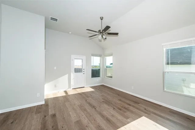 wooden floor in an empty room with a window