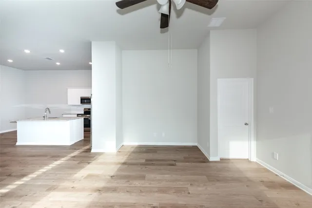 a view of kitchen and hall with wooden floor