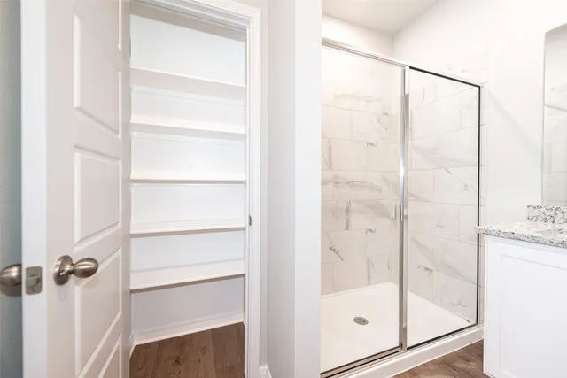 a bathroom with a glass shower door