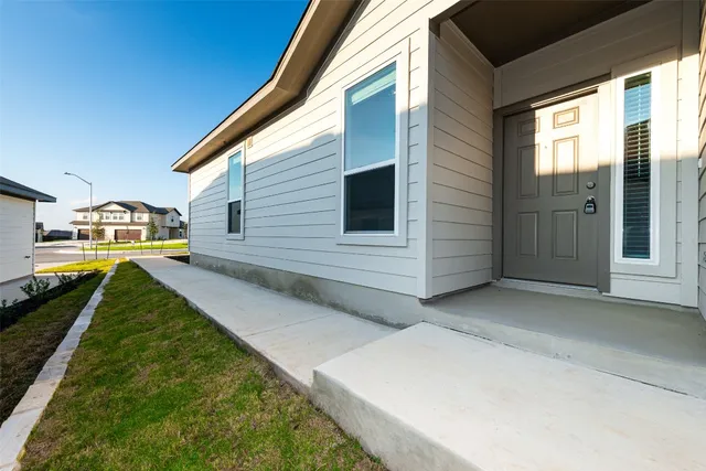 a view of house with backyard