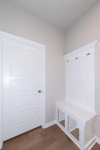 a bathroom with a bathtub shower sink vanity mirror and toilet