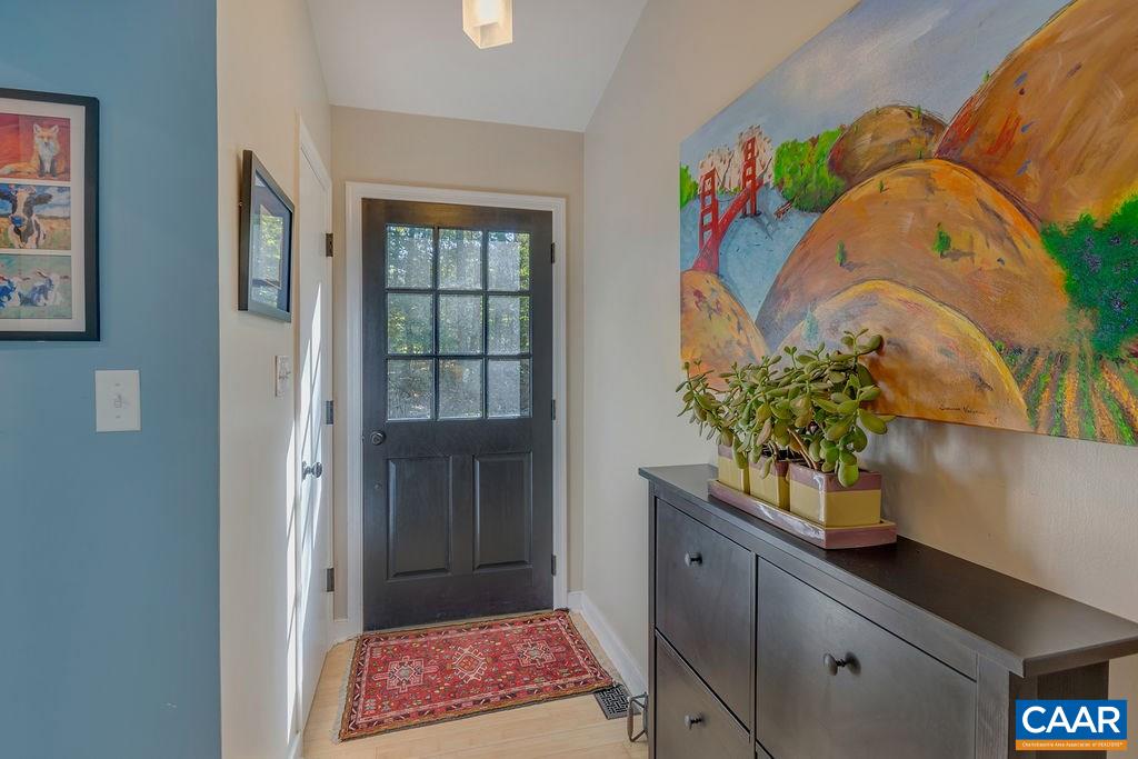 2608 Rio Mills Road Earlysville, VA 22936 - Photo 12 of 38 a room with painting on the wall and a potted plant