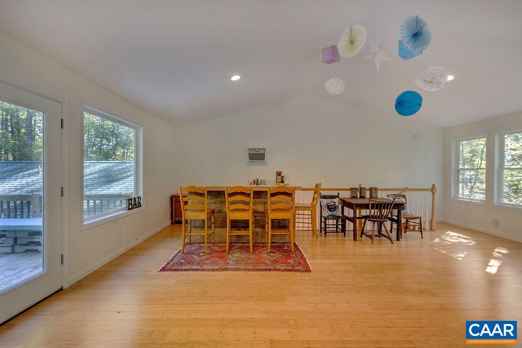 2608 Rio Mills Road Earlysville, VA 22936 - Photo 22 of 38 a dining room with furniture and a floor to ceiling window