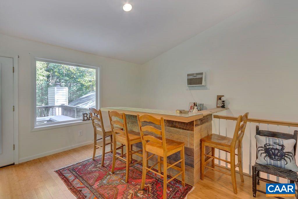 2608 Rio Mills Road Earlysville, VA 22936 - Photo 23 of 38 a view of a dining room with furniture a rug and wooden floor