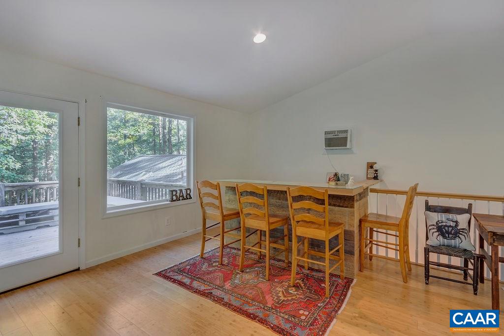 2608 Rio Mills Road Earlysville, VA 22936 - Photo 24 of 38 a dining room with furniture and wooden floor