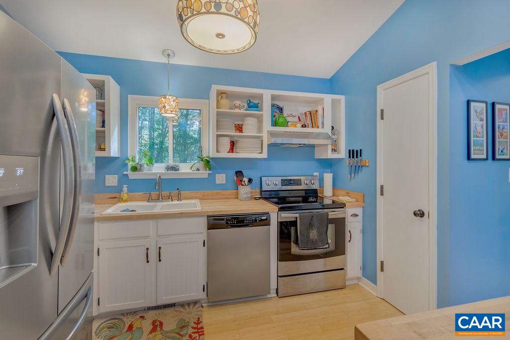 2608 Rio Mills Road Earlysville, VA 22936 - Photo 8 of 38 a kitchen with stainless steel appliances a stove a sink and a refrigerator