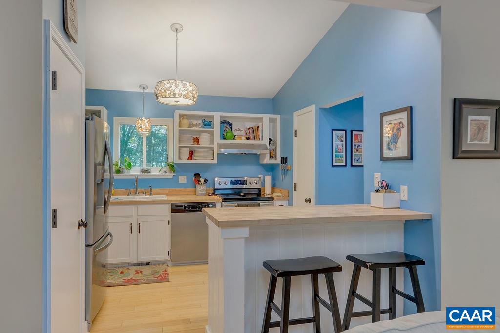 2608 Rio Mills Road Earlysville, VA 22936 - Photo 9 of 38 a kitchen with a table chairs refrigerator and cabinets