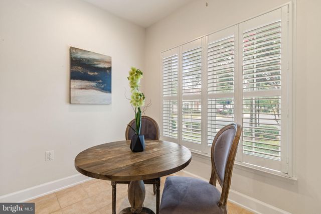 a view of a dining room with furniture and window