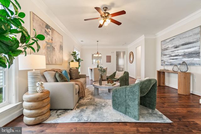 a living room with furniture rug and wooden floor