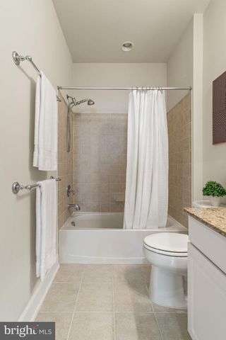 a bathroom with a bathtub shower sink and toilet