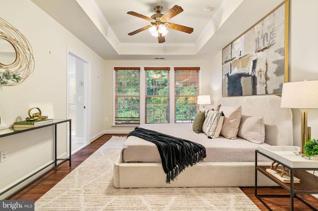 a bedroom with a large bed and a chandelier