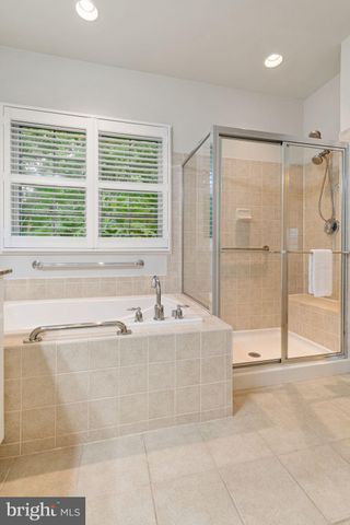 a spacious bathroom with a tub and a shower