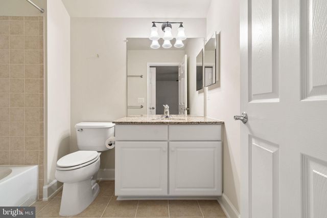 a bathroom with a sink vanity and a toilet