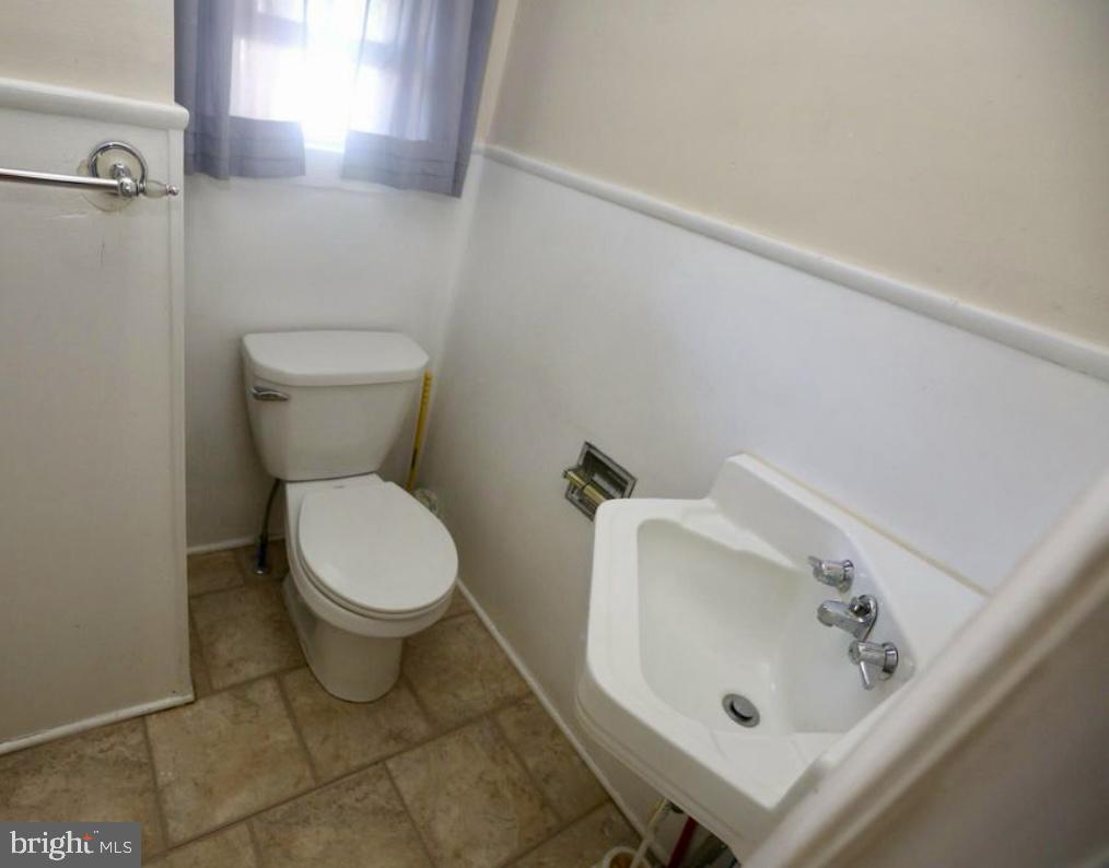 310 Ellis Street Glassboro, NJ 08028 - Photo 10 of 15 a white toilet sitting next to a bathroom sink