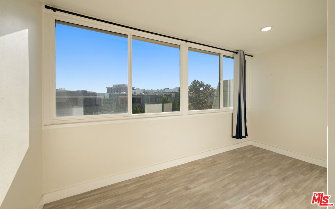 13206 Admiral Avenue, Unit F Marina del Rey, CA 90292 - Photo 11 of 21 a view of an empty room with wooden floor and a window