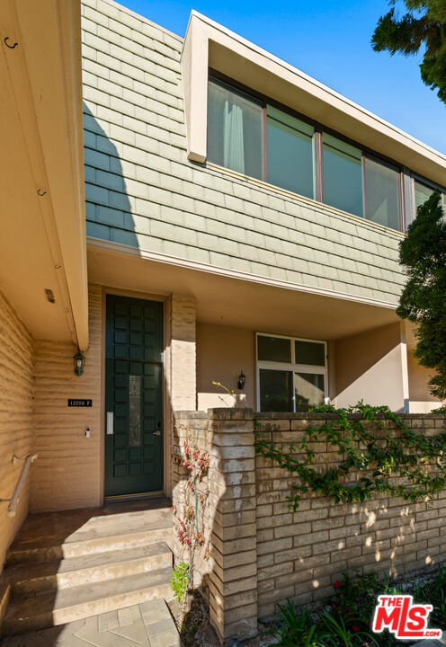 13206 Admiral Avenue, Unit F Marina del Rey, CA 90292 - Photo 16 of 21 a front view of a house with a garden