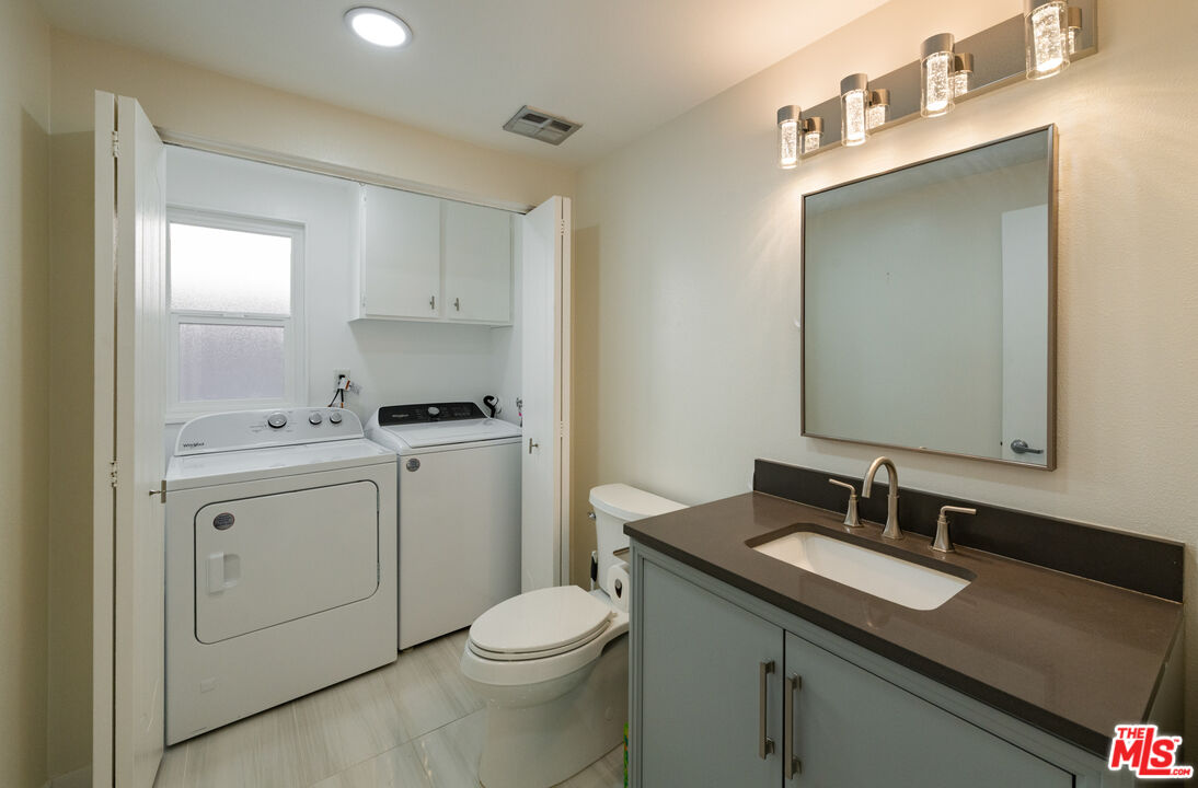 13206 Admiral Avenue, Unit F Marina del Rey, CA 90292 - Photo 9 of 21 a bathroom with a granite countertop sink toilet and mirror