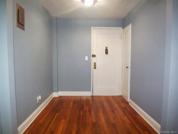 a view of a room with wooden floor