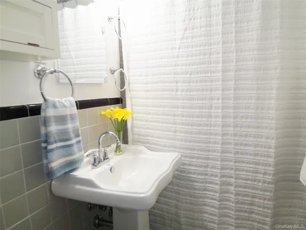 a bathroom with a sink a mirror and shower
