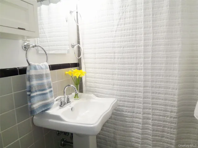 a bathroom with a sink a mirror and shower
