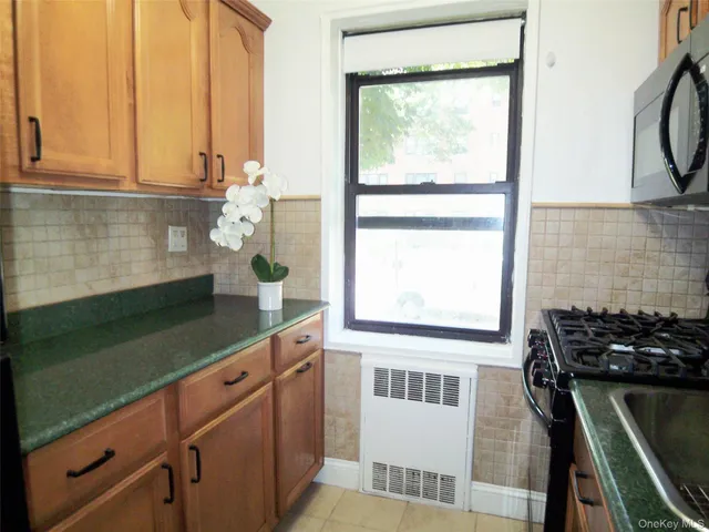 a kitchen with a sink a window and cabinets