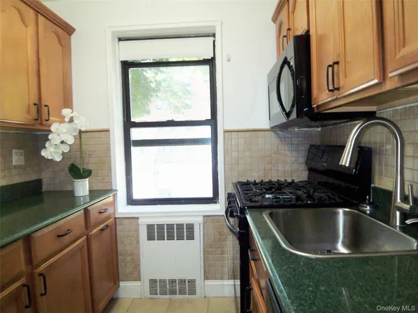 a kitchen with granite countertop a sink and a window