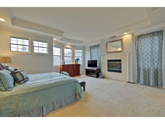 10171 Carmen Road Cupertino, CA 95014 - Photo 15 of 25 a bedroom with a bed and a television