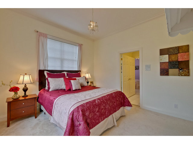 10171 Carmen Road Cupertino, CA 95014 - Photo 16 of 25 a bedroom with a bed and a night stand