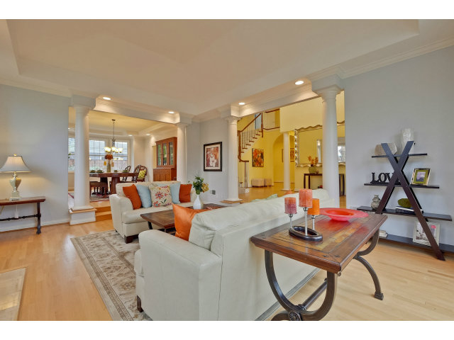 10171 Carmen Road Cupertino, CA 95014 - Photo 5 of 25 a living room with furniture a rug and a chandelier