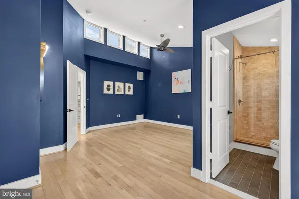a view of an empty room with a ceiling fan