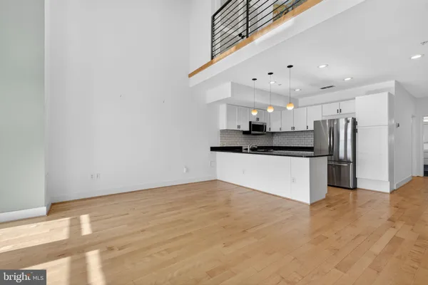 a view of kitchen with refrigerator and microwave