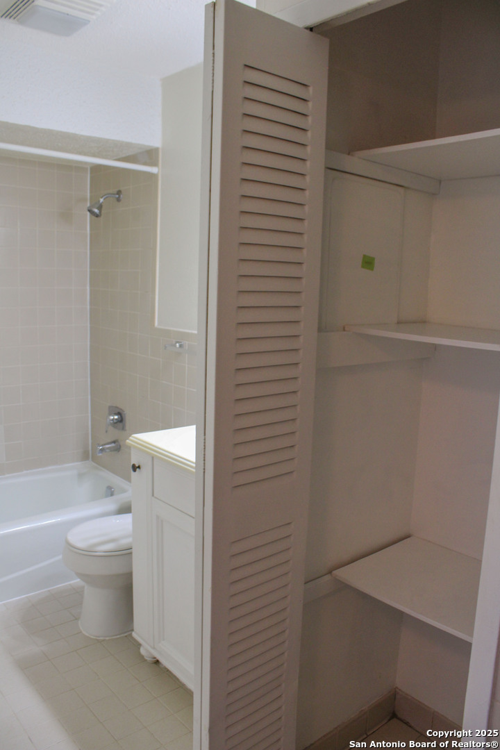 923 Vance Jackson Road, Unit 1007 San Antonio, TX 78201 - Photo 16 of 43 a bathroom with a toilet and a shower