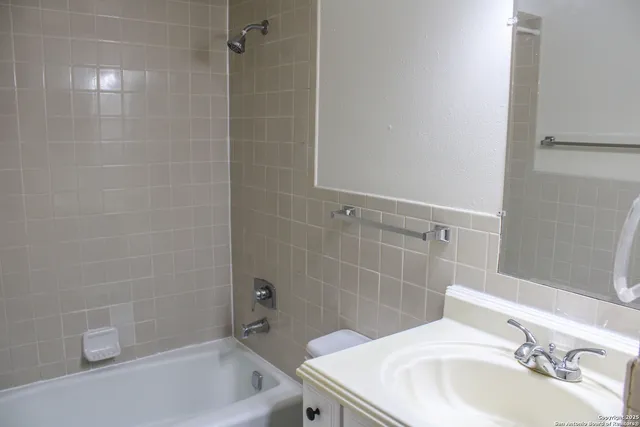 a bathroom with a shower a toilet and sink