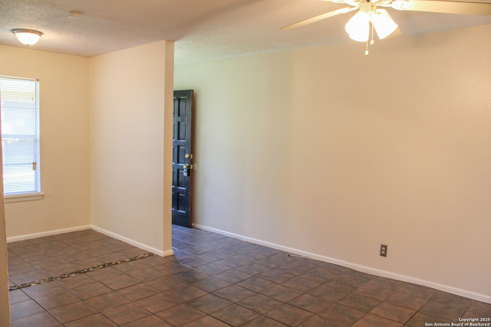 923 Vance Jackson Road, Unit 1007 San Antonio, TX 78201 - Photo 22 of 43 an empty room with a chandelier fan and windows