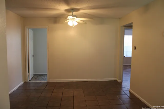a view of a pathway of a house with wooden fence