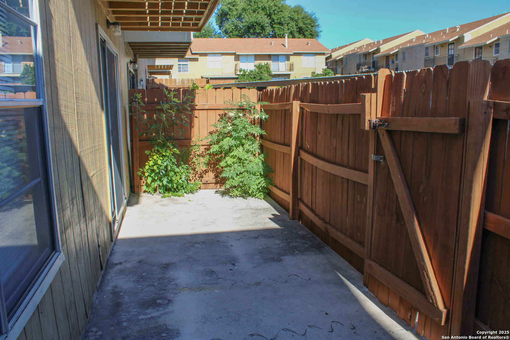 923 Vance Jackson Road, Unit 1007 San Antonio, TX 78201 - Photo 25 of 43 a view of a pathway of a house with wooden fence