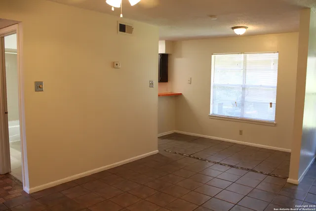 an empty room that has a mirror