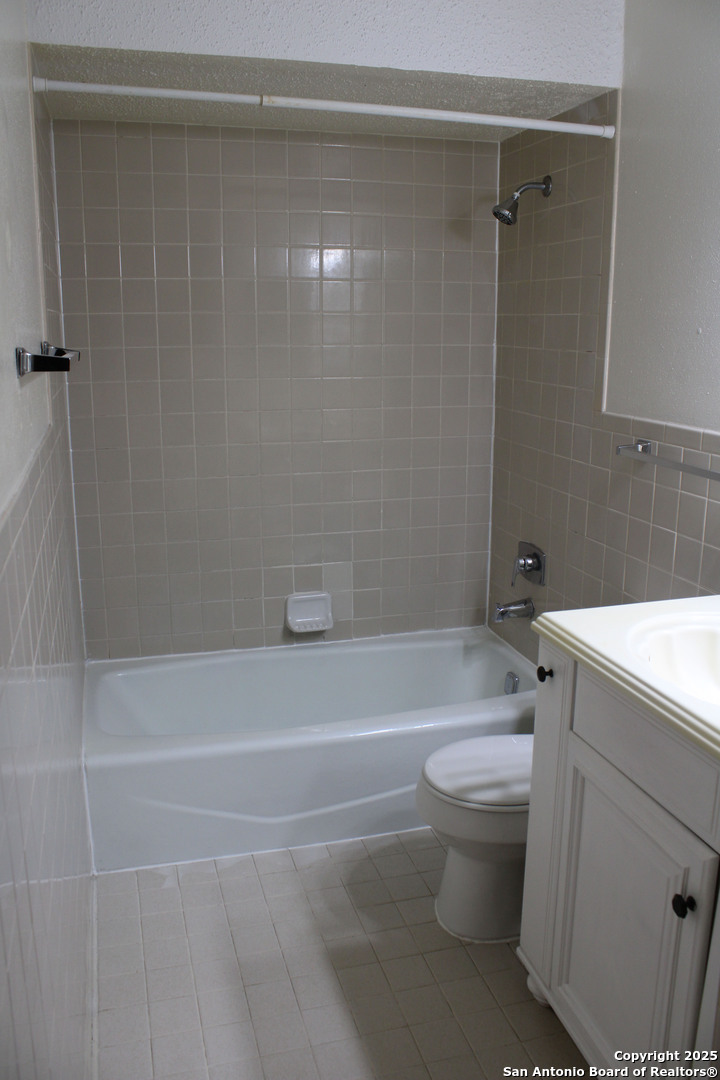 923 Vance Jackson Road, Unit 1007 San Antonio, TX 78201 - Photo 39 of 43 a bathroom with a sink a toilet and shower
